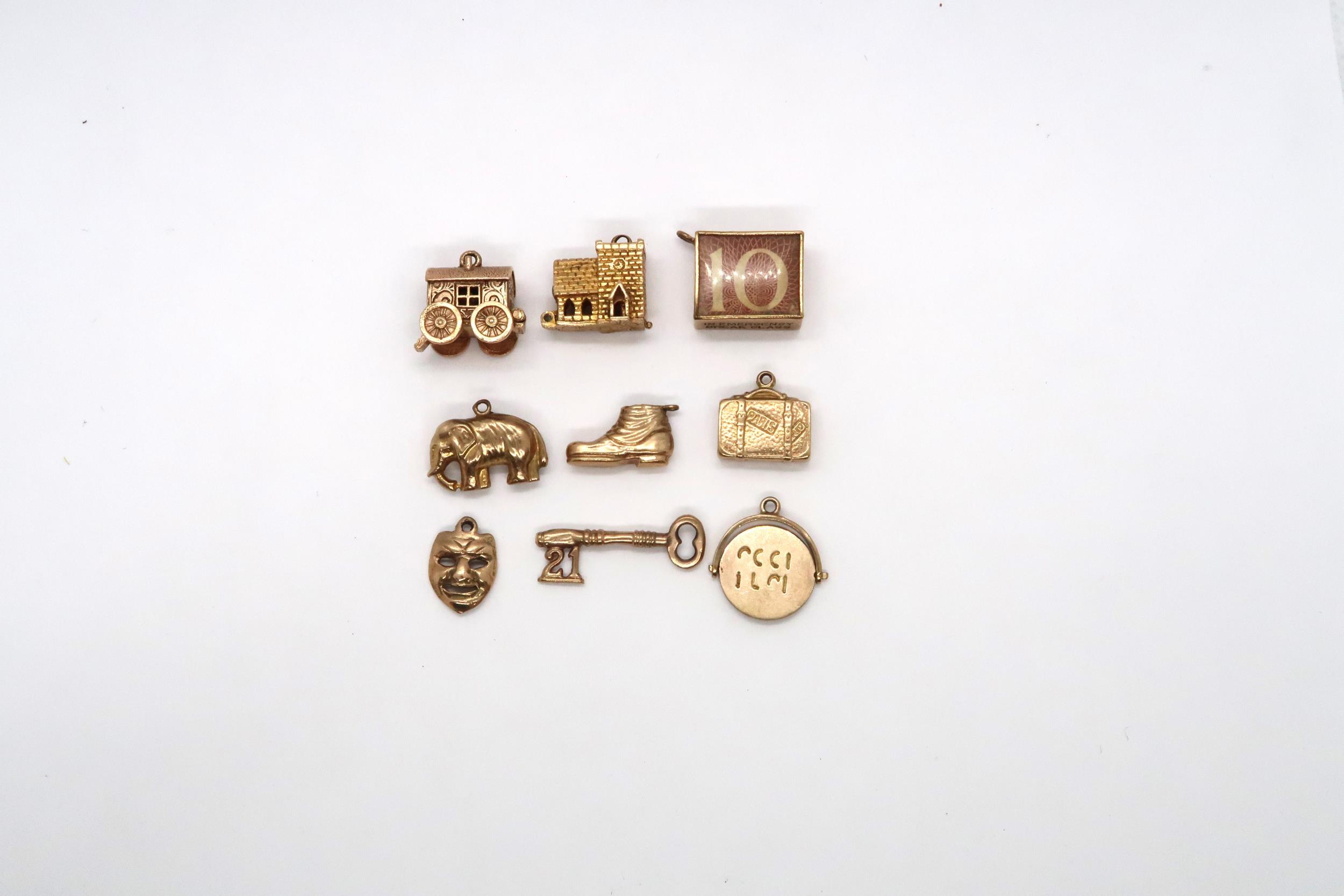 Nine, 9ct Yellow Gold charms in the form of a miniature Vesta, elephant, etc.. Total weight 14.1