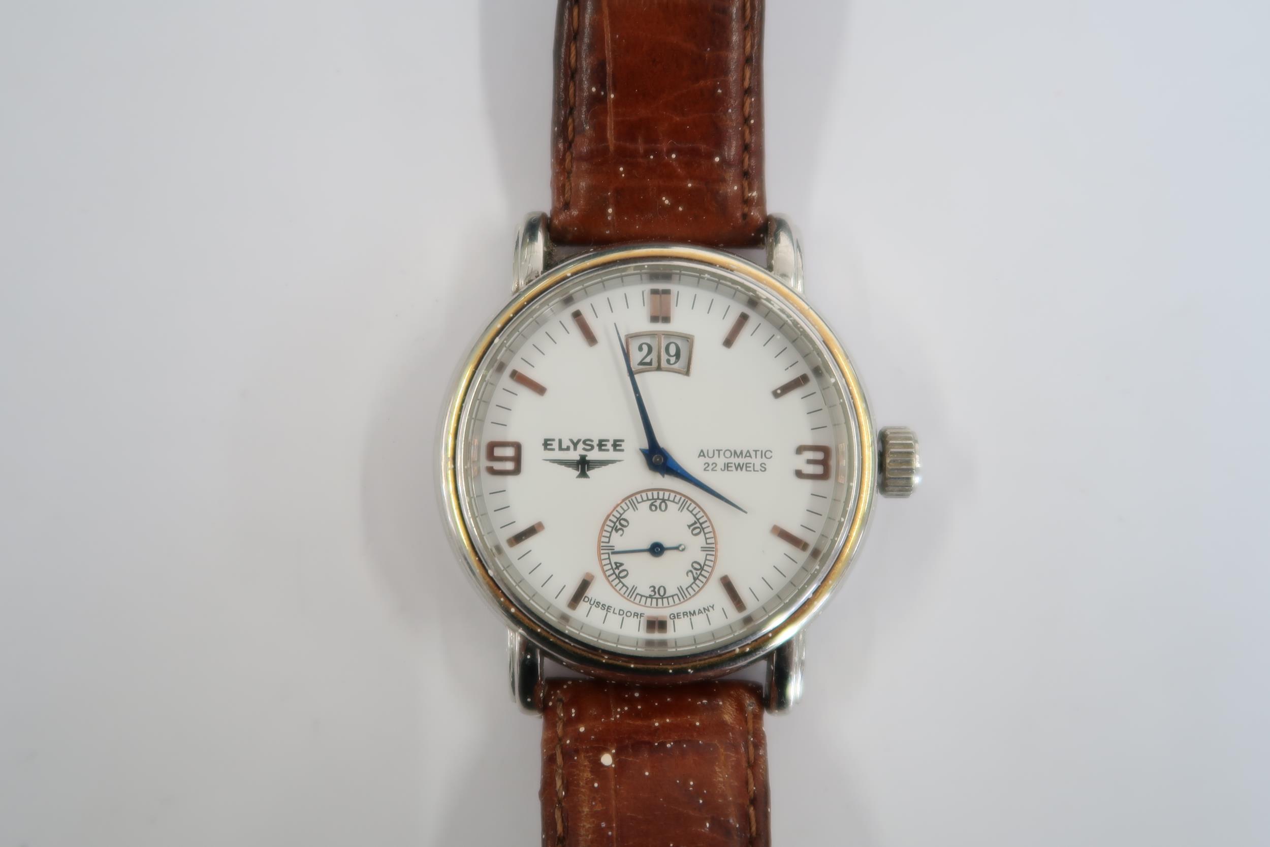 A Gents Elysee auto day/date watch on a brown leather strap, running in saleroom