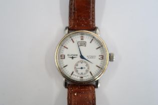 A Gents Elysee auto day/date watch on a brown leather strap, running in saleroom