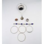 An assortment of nine pieces of silver and white metal jewellery. To include an agate pendant and