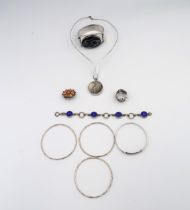 An assortment of nine pieces of silver and white metal jewellery. To include an agate pendant and