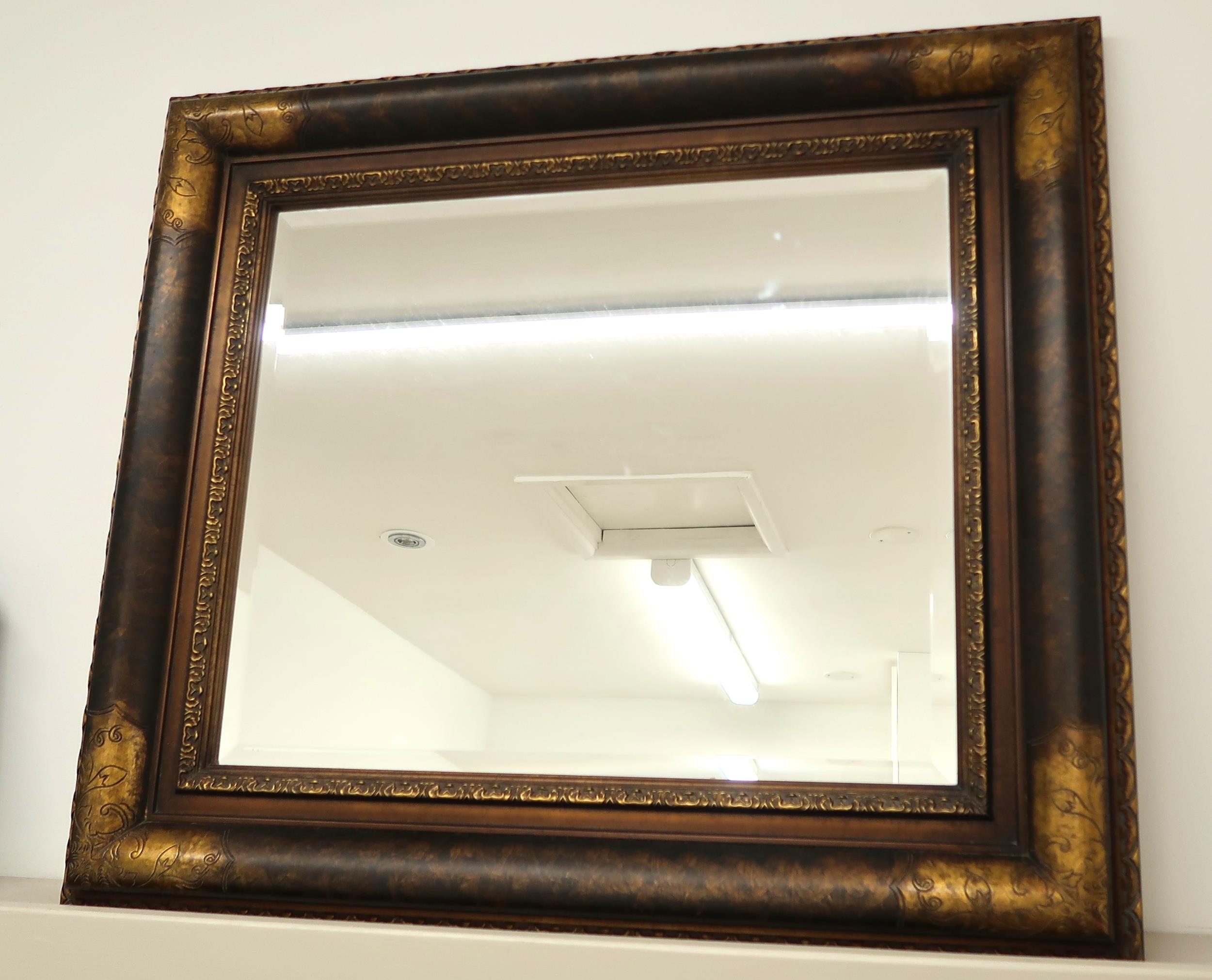 A modern mirror with bevelled edged glass - 84cm x 74cm