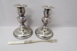 A pair of silver plated candlesticks and toasting fork