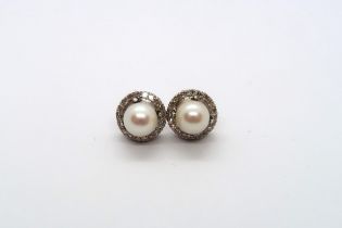 An 18ct white gold pearl and diamond earrings, head size approx 12mm diameter, pearls approx 8mm