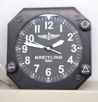 A Breitling advertising wall clock finished in black lacquer metal. 27.8cm across face.
