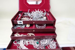 A quantity of costume jewellery to include tiara, pendants, brooches, necklaces etc. in a