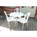 A cast iron garden table and three chairs - Diameter 81.5cm x Height 68cm