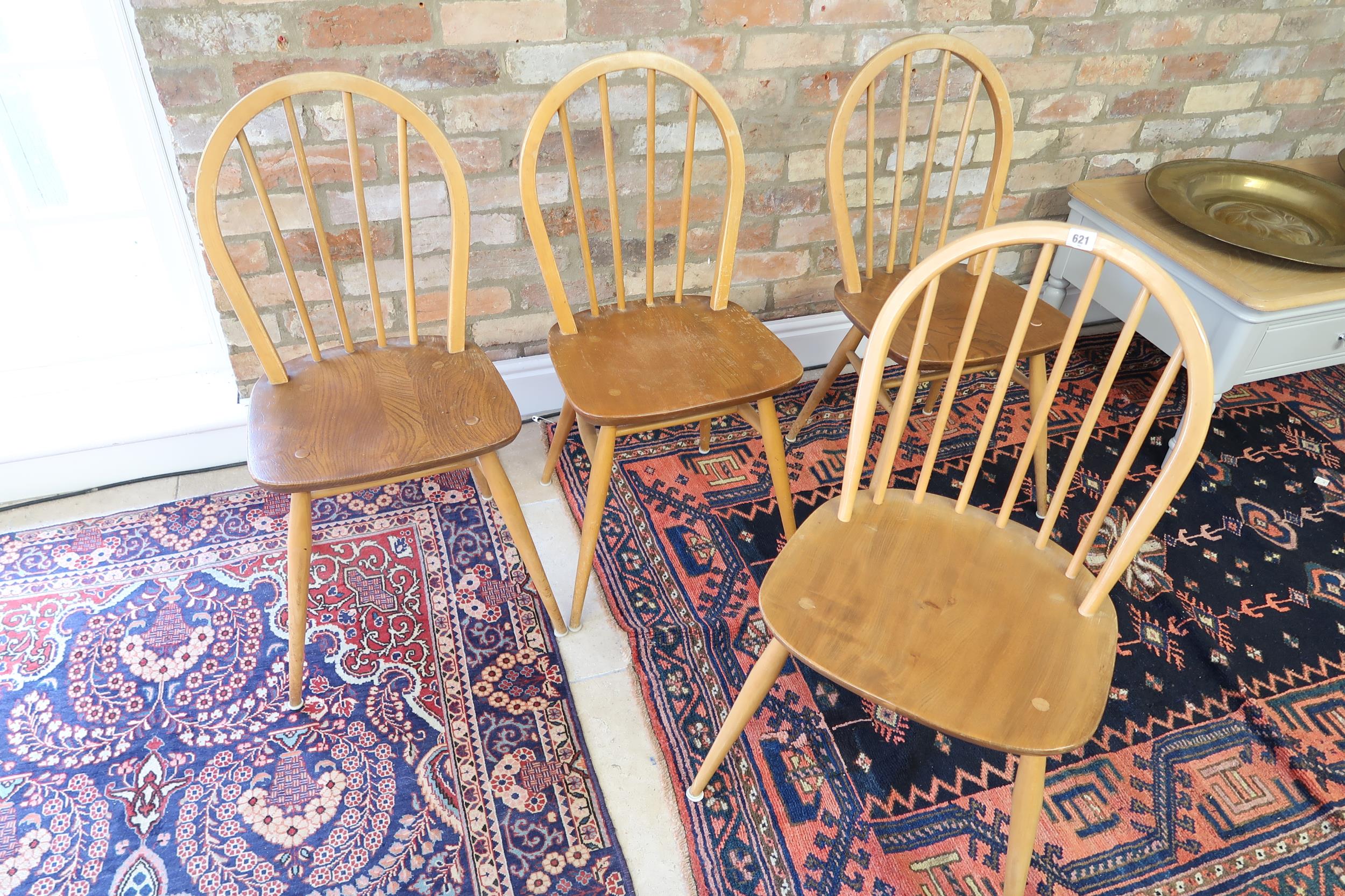 A set of four light Ercol dining chairs