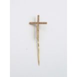 A yellow gold crucifix with pin, diamonds to field, approx 2.7 grams