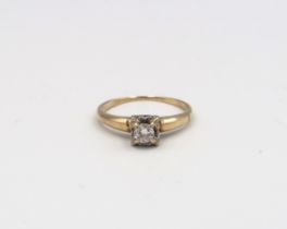 An illusion set 14ct yellow gold and diamond solitaire ring with chip - ring size M - 1.9 grams