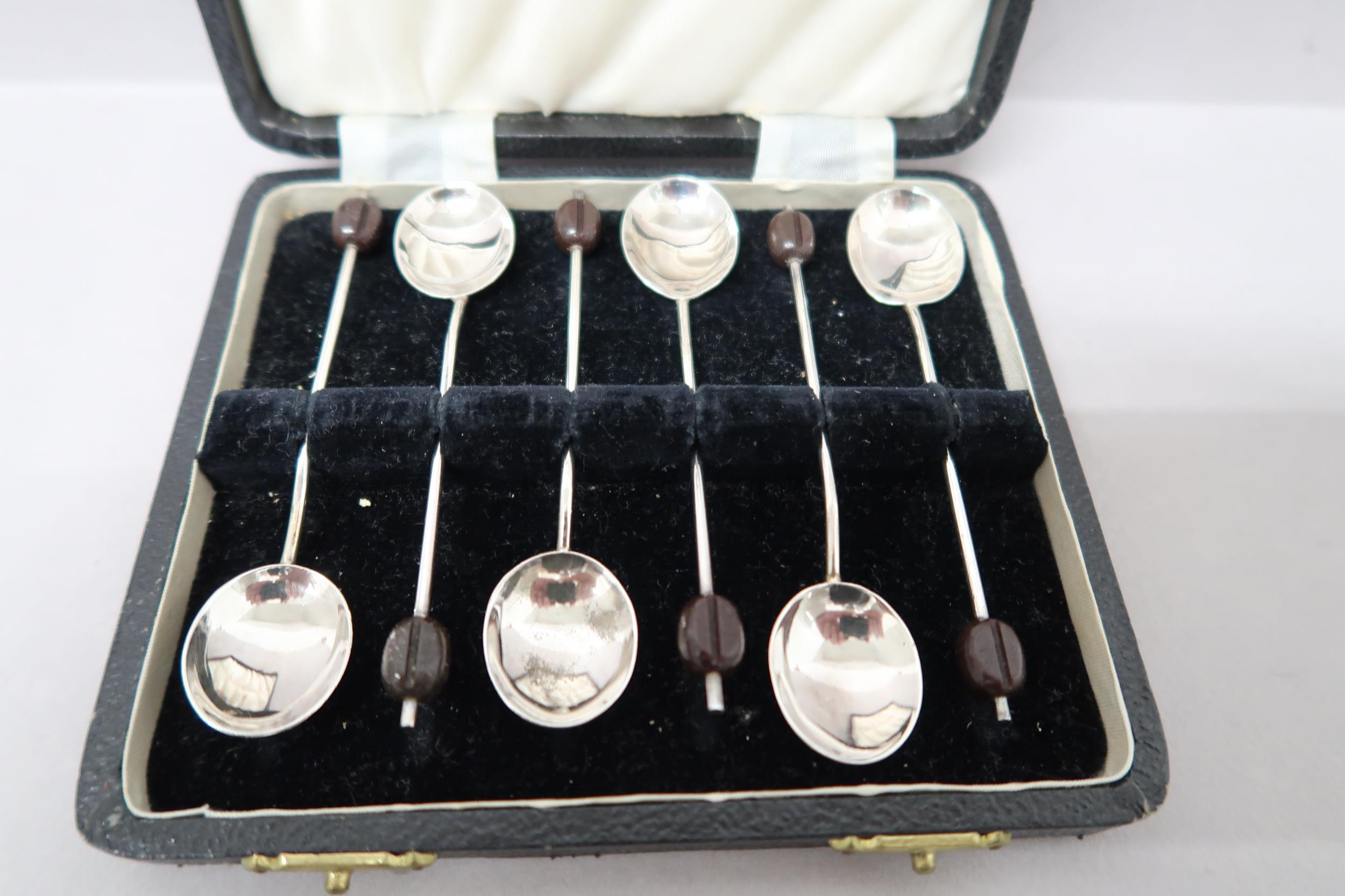 A cased set of coffee bean spoons