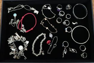 A quantity of silver jewellery: silver rings, bangles, silver charm bracelet, Links of London charms