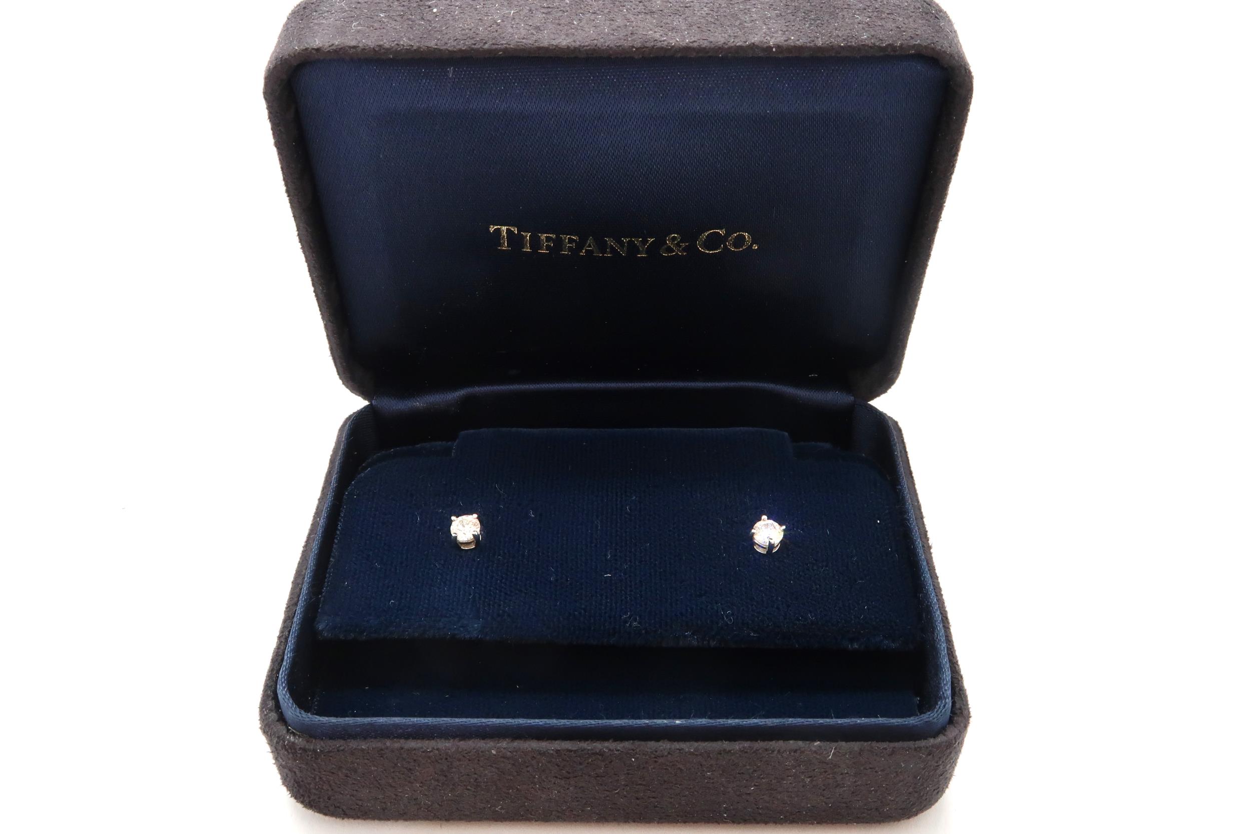 A pair of Tiffany diamond stud earrings, in Tiffany box