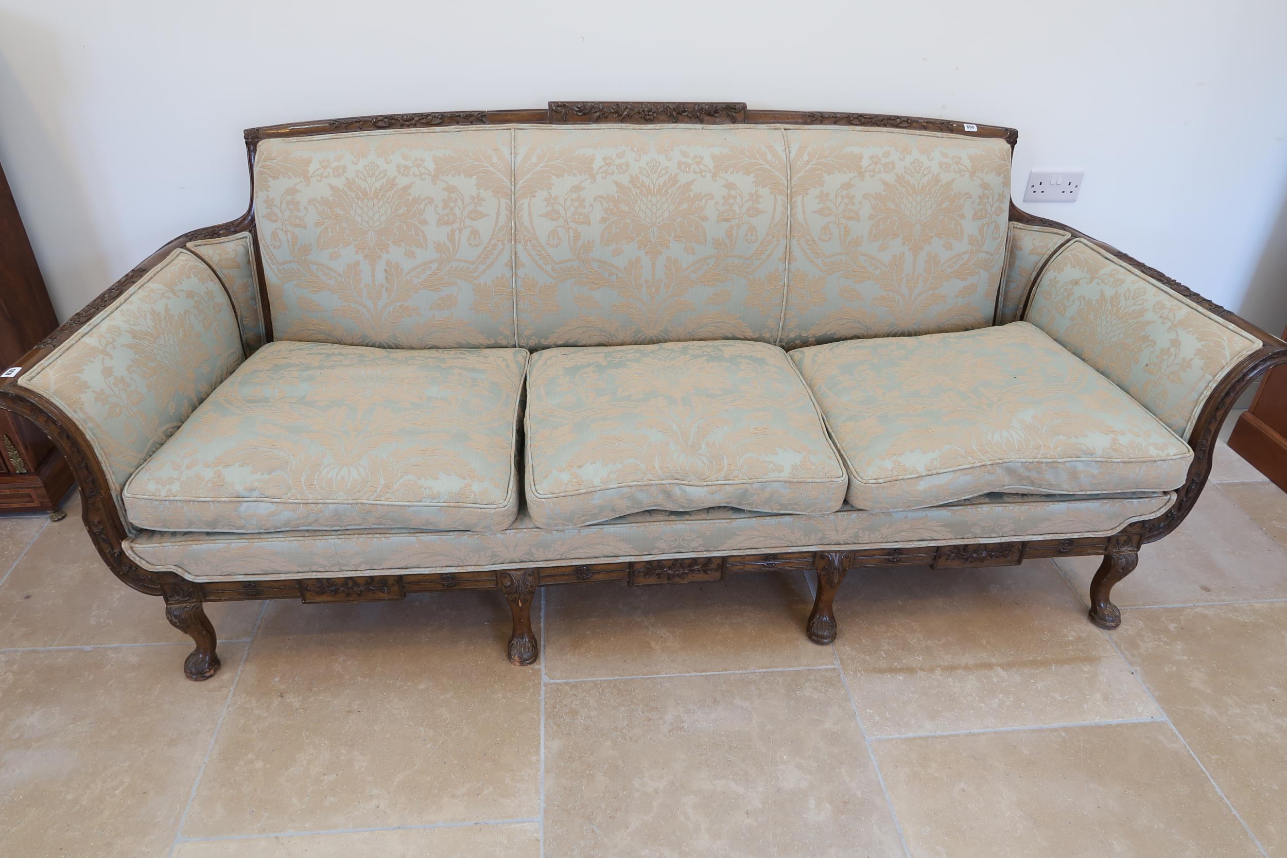 A large carved mahogany settee raised on four cabriole legs, 238cm wide