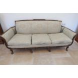 A large carved mahogany settee raised on four cabriole legs, 238cm wide