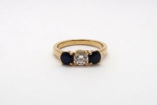 An 18ct yellow gold (hallmarked) three stone diamond and sapphire ring with accompanying insurance