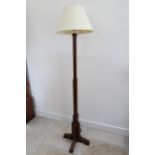 An Art Deco oak standard lamp and shade in working order