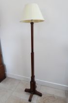 An Art Deco oak standard lamp and shade in working order