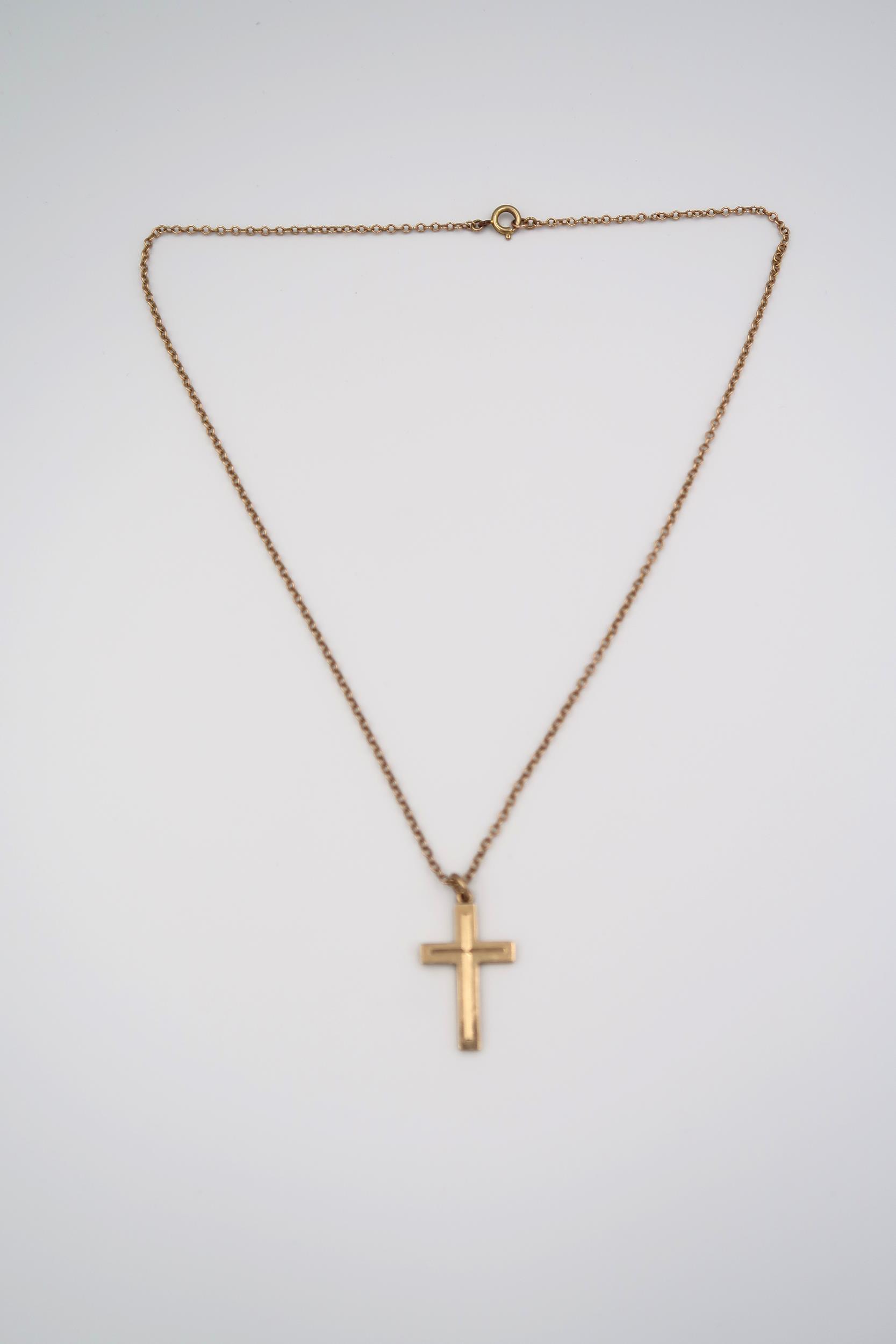 A 9ct gold cross pendant suspended from 430mm belcher link chain stamped 9ct. Weight 4.80 grams.