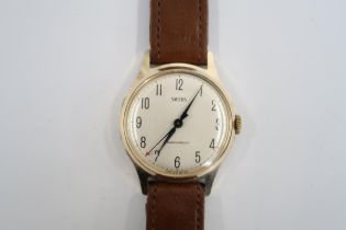 A gents Smiths automatic on a brown leather strap, running in saleroom