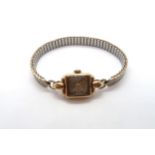 A 9ct yellow gold cased ladies watch on a bi-metal bracelet