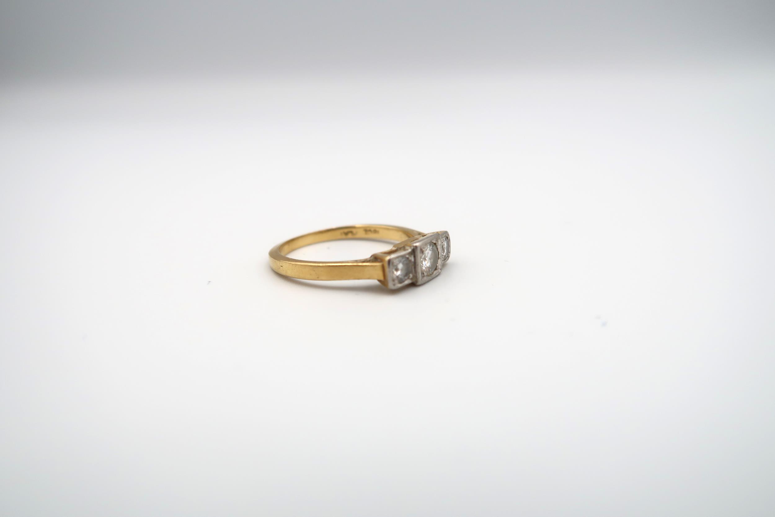 A brilliant cut diamond three stone ring. Estimated total diamond weight 0.50ct. Estimated H/I - Image 2 of 3