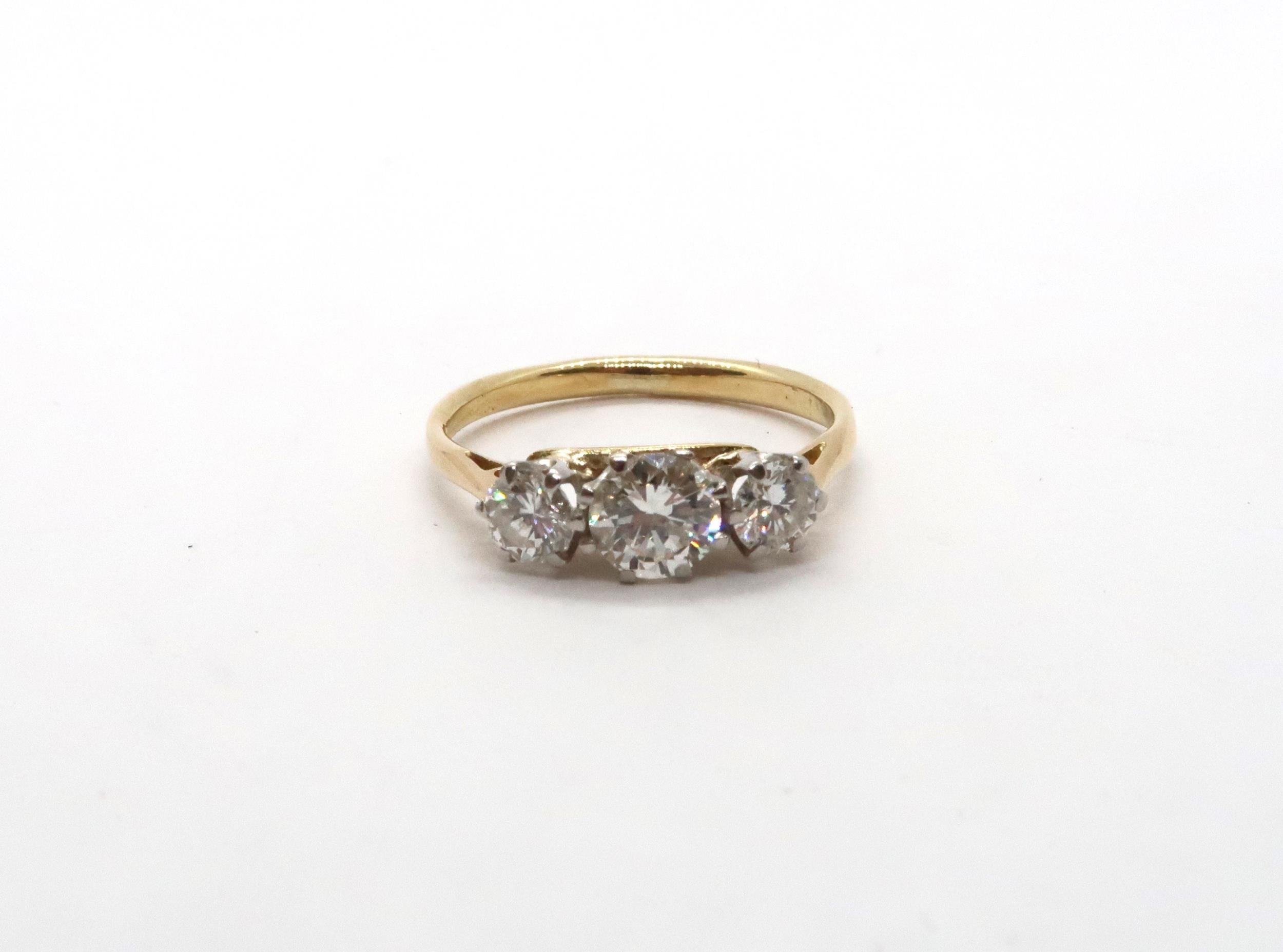 A three stone diamond and yellow metal ring, estimated I/J colour SI1- SI2 clarity, approx 0.75ct,