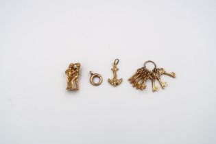9ct yellow gold in the form of miniature keys, charms etc. approx 8.4 grams