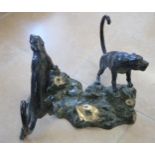 A large bronze sculpture of opposing Jaguars climbing tree stump, signature to one corner - Height