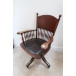 An early 20th century mahogany framed revolving desk chair