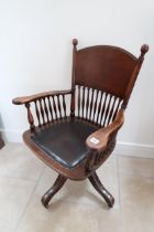 An early 20th century mahogany framed revolving desk chair