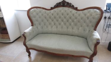 A 19thc walnut continental framed settee with a buttoned back, nicely upholstered and in good