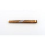 A 9ct yellow gold tie clip, white gold to centre with small rough cut diamond, approx 3.2 grams