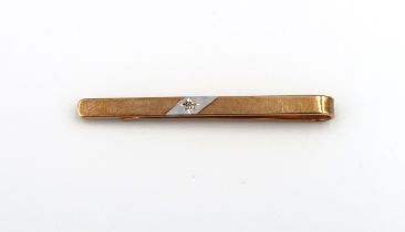 A 9ct yellow gold tie clip, white gold to centre with small rough cut diamond, approx 3.2 grams