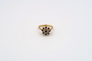 A 9ct gold sapphire and single cut diamond cluster ring with bark effect shoulders. Weight 3.49