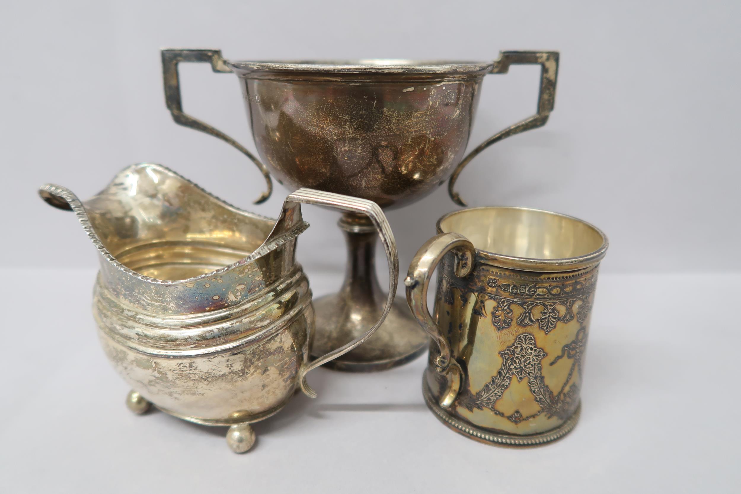 A hallmarked silver cup decorated with bows and swags, London 1873 Martin Hall & Co, and a silver