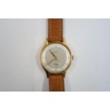 A Gents Smiths Deluxe automatic watch on a brown leather strap, running in saleroom