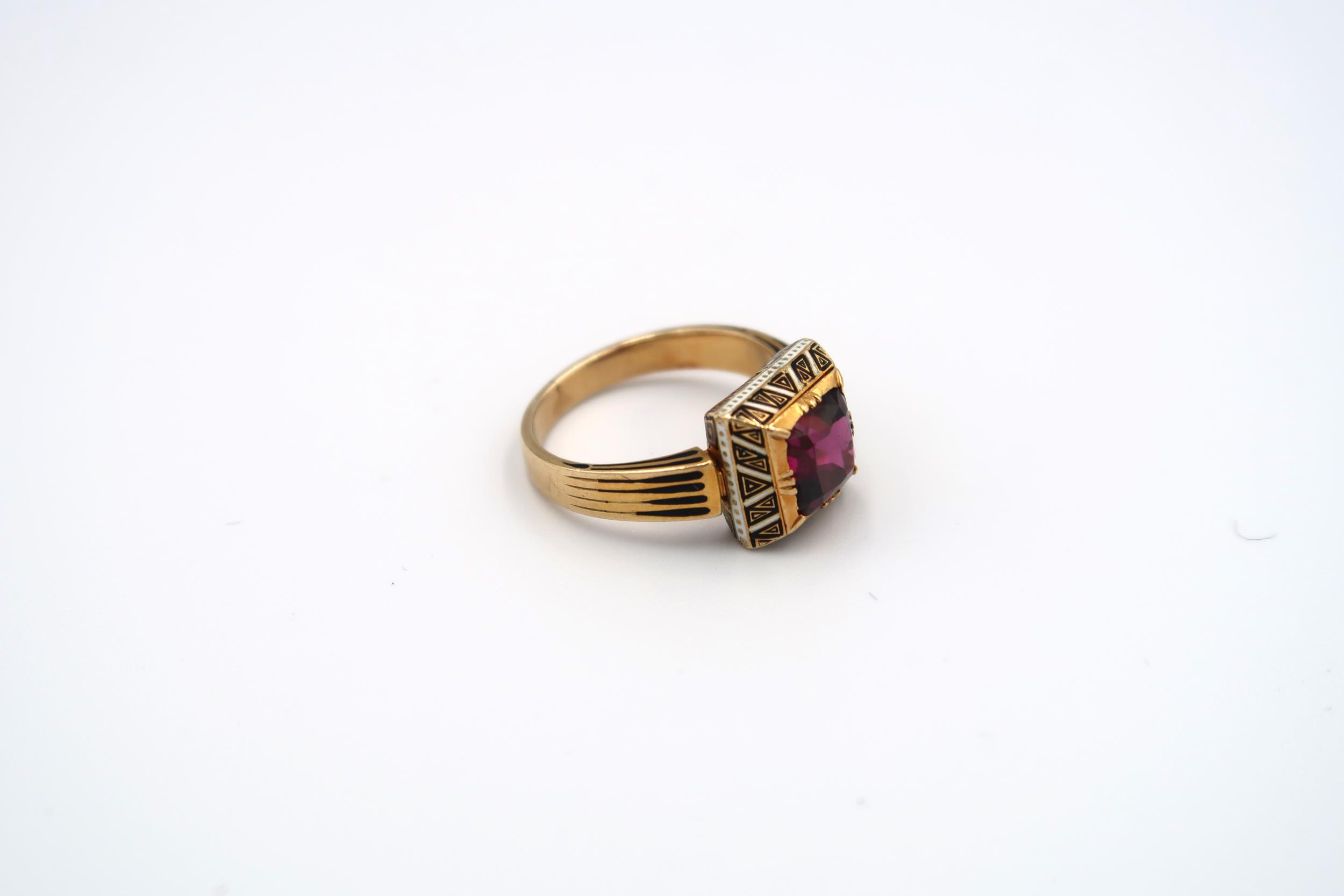 A garnet and enamel ring believed to be 19th century. Tested gold 18ct. Weight 6.47 grams. Ring size - Image 2 of 3