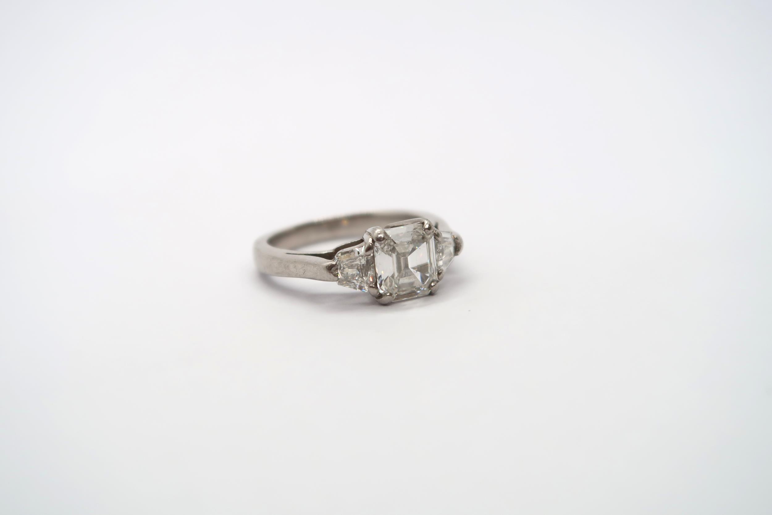 A very good platinum three stone diamond ring - The square emerald cut diamond estimated 1.1ct - Image 4 of 11