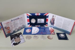 Seven pure silver proof coins and a Britannia two pound sterling silver bullion coin and a ten pound