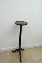 A mahogany torchere /jardiniere stand with turned and fluted column on tripod legs - Height 112cm