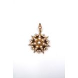 A seed pearl starburst pendant. Length 40mm. Width 30mm. Tests as approximately 15ct gold. Weight