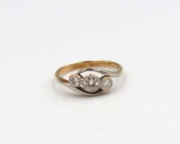 An old cut diamond three stone crossover ring. Estimated total diamond weight 0.35ct. Estimate I/J