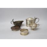 A silver hallmarked mustard without liner, London, a small twin handled cup, Birmingham, a napkin