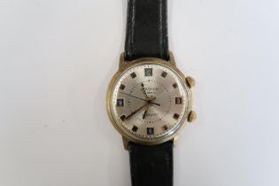 A Gents Seconda 18 Jewel Shockproof wristwatch on a black leather watch, running in saleroom