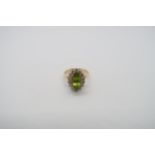 An 18ct yellow gold marquis cut peridot and diamond ring, peridot is good colour, diamonds bright