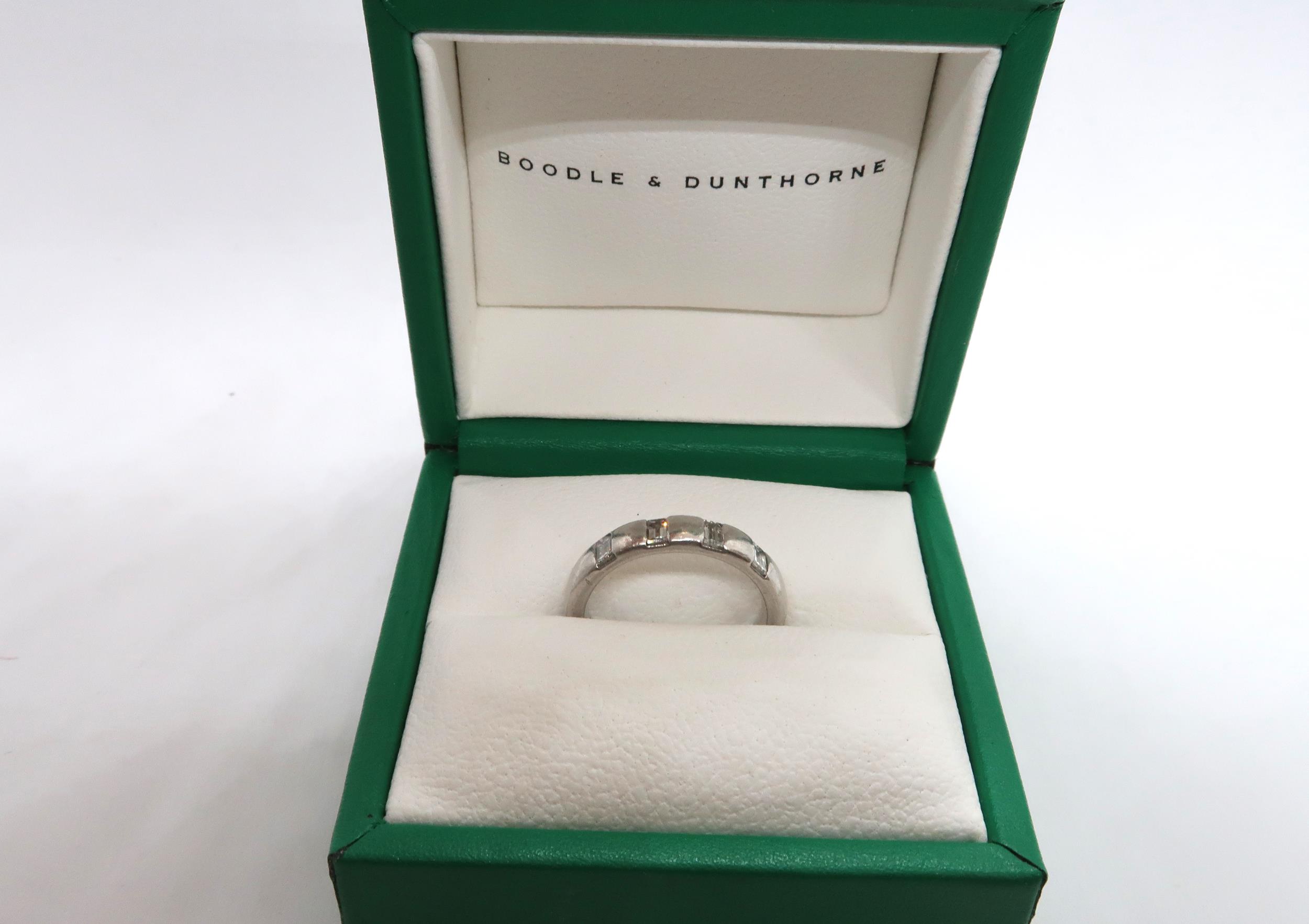 A Boodles platinum four stone diamond ring, the band set with four emerald cut diamonds, ring size L - Image 3 of 3
