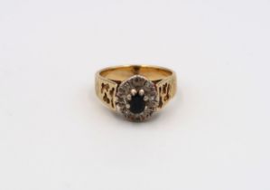 A Poss 18ct yellow and white gold dress ring with oval cut sapphire surrounded by 8 small old cut