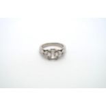 A very good platinum three stone diamond ring - The square emerald cut diamond estimated 1.1ct