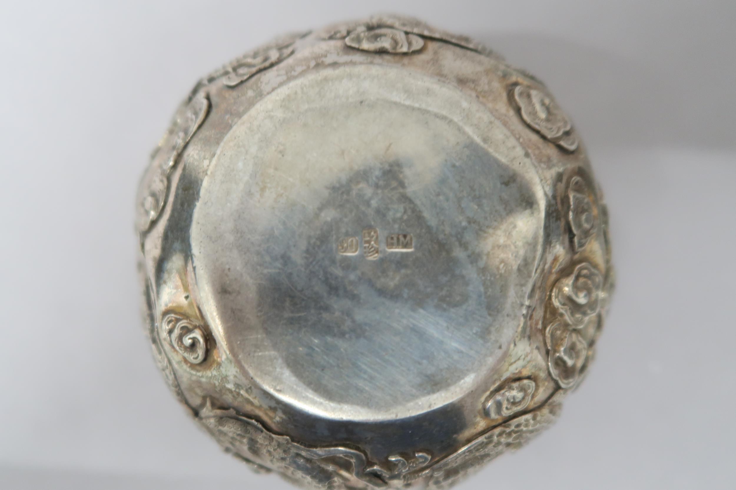 A Chinese silver bowl marked 90 decorated with opposing dragons amongst foliage - Image 2 of 2